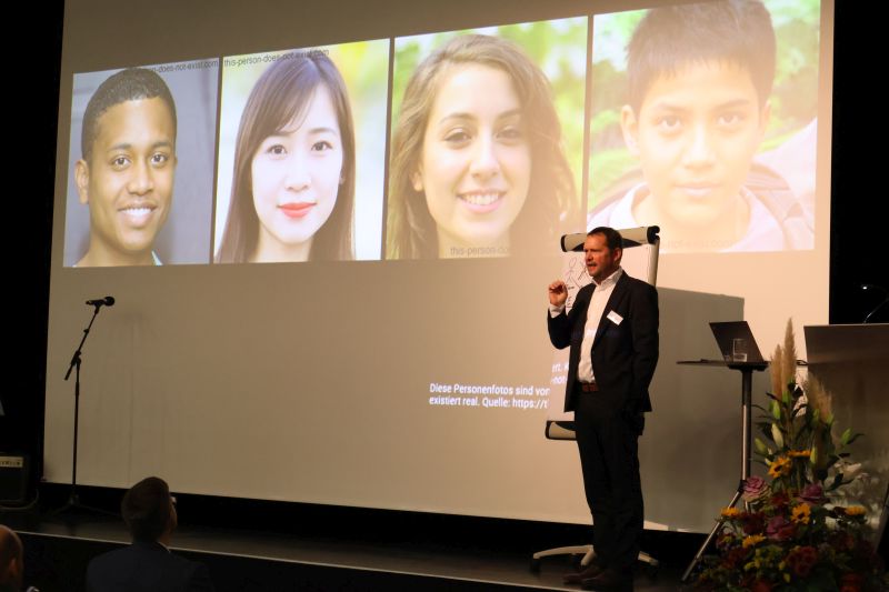 Referent Heiner Lasi, Professor für Industrial Intelligence und seit 2015 Leiter des Ferdinand-Steinbeis-Instituts mit Sitz in Heilbronn und Stuttgart, steht auf der Bühne vor einer Leinwand, auf der mehrere Fotos von Personen zu sehen sind. Referent Heiner Lasi, Professor für Industrial Intelligence und seit 2015 Leiter des Ferdinand-Steinbeis-Instituts mit Sitz in Heilbronn und Stuttgart, steht auf der Bühne vor einer Leinwand, auf der mehrere Fotos von Personen zu sehen sind.